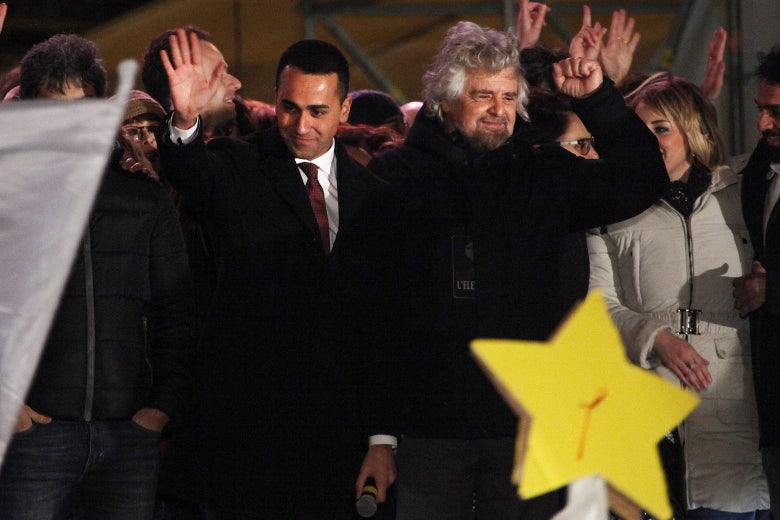 Luigi Di Maio and Beppe Grillo wave at the crowd.